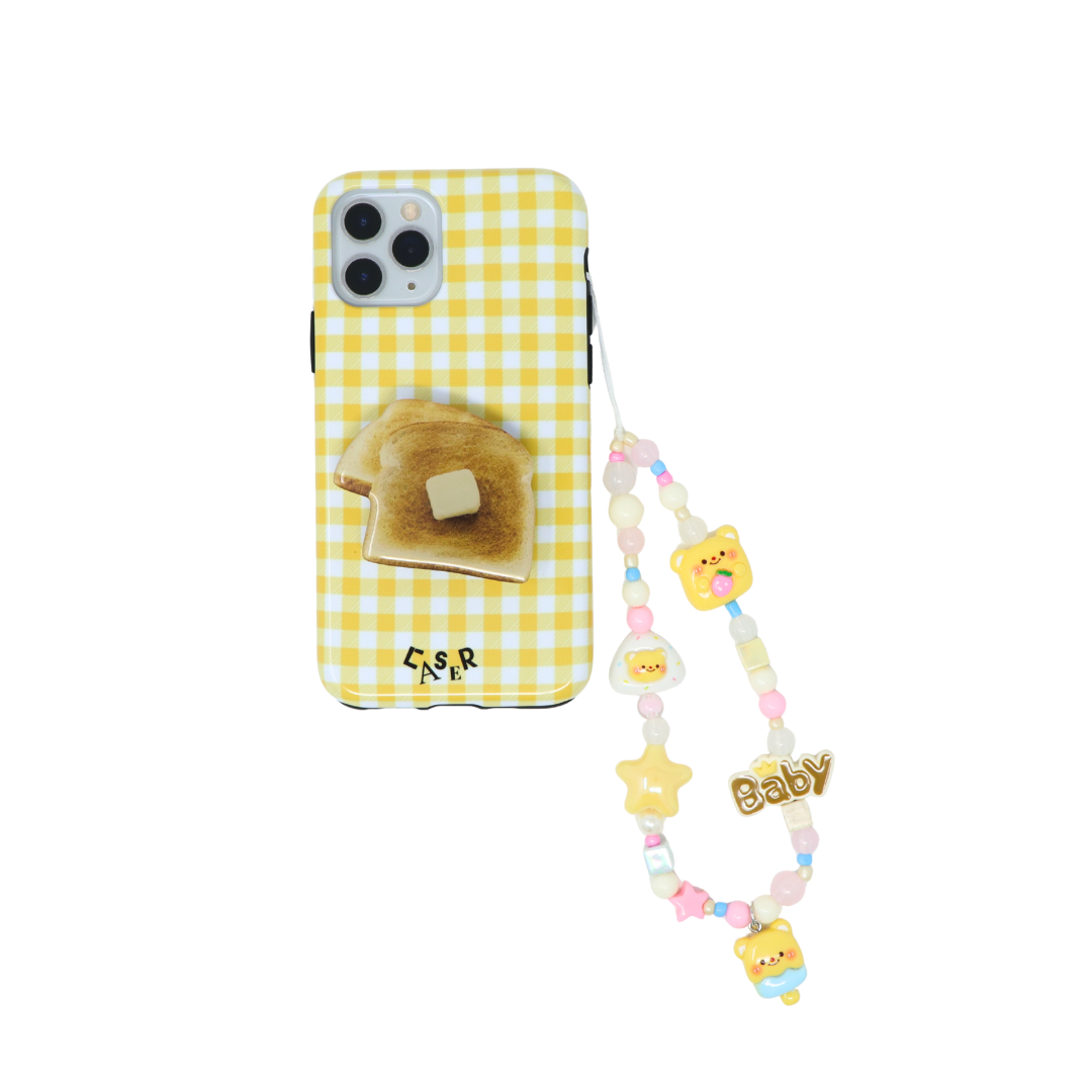 yellow plaid phone case with toast phone grip and a butter bear phone charm