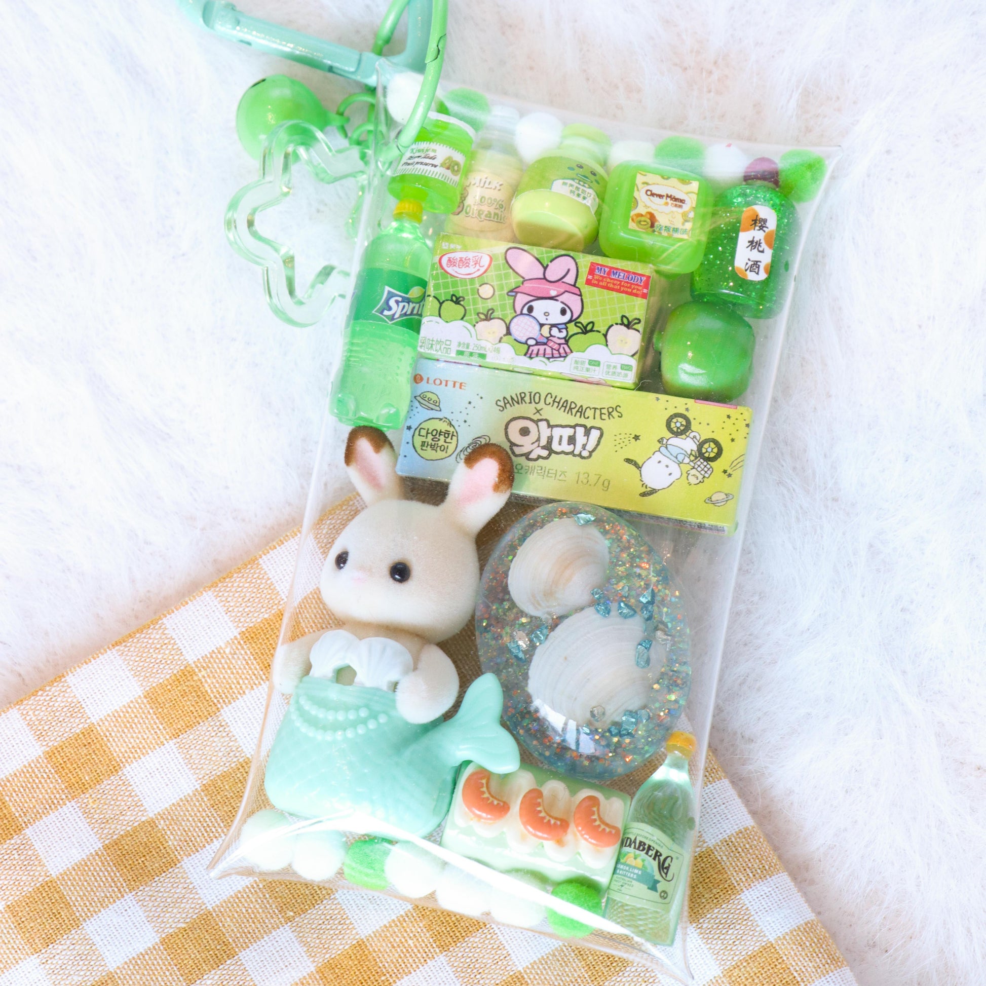 Packaged toy with a green heart-shaped holder on a checkered fabric background