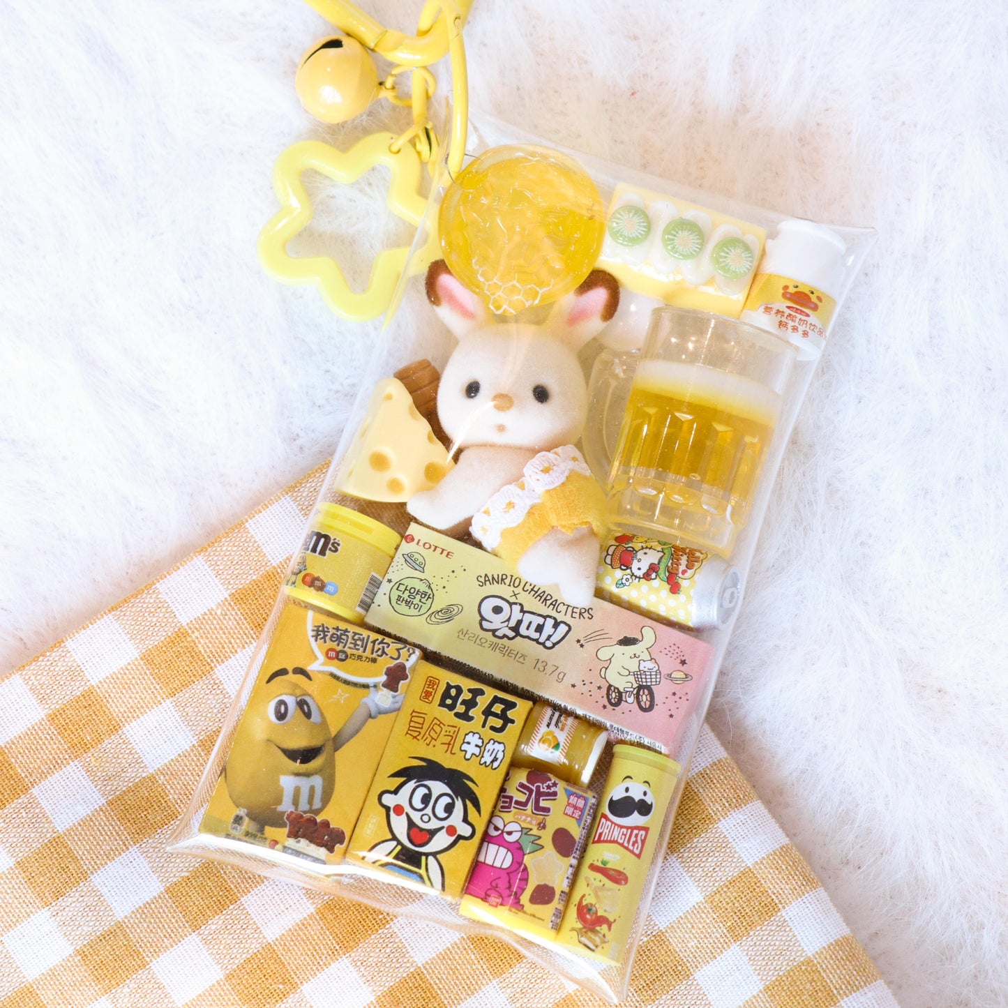 Packaged toy with a keychain on a checkered fabric background